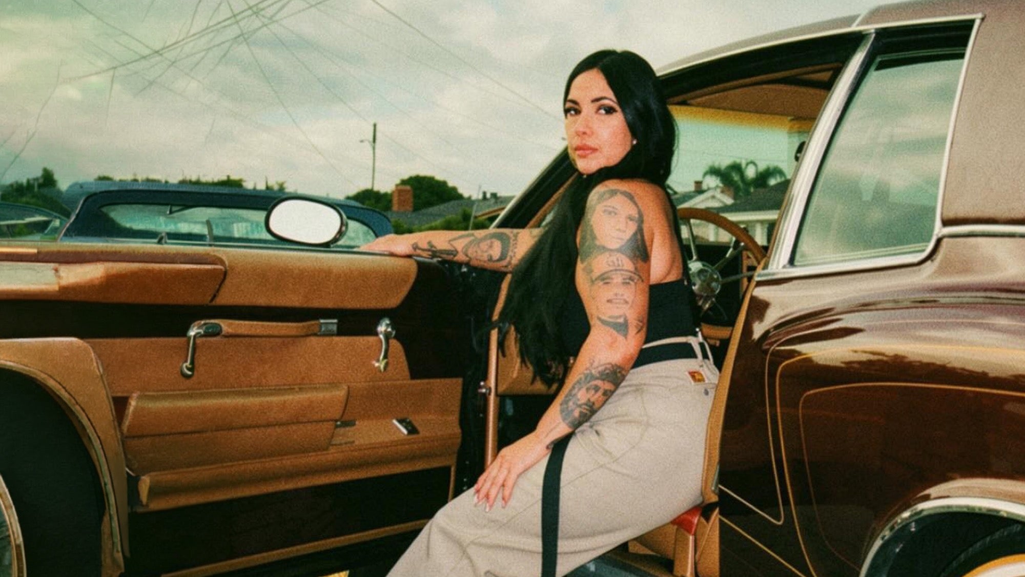 Chula Cholita — Founder Erica next to a lowrider